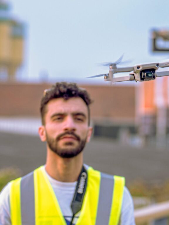 Een student van HET BUREAU met een drone in de lucht tijdens de Elfstedentriatlon.